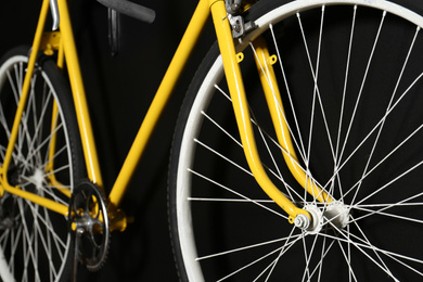 Photo of Yellow bicycle on black background, closeup view