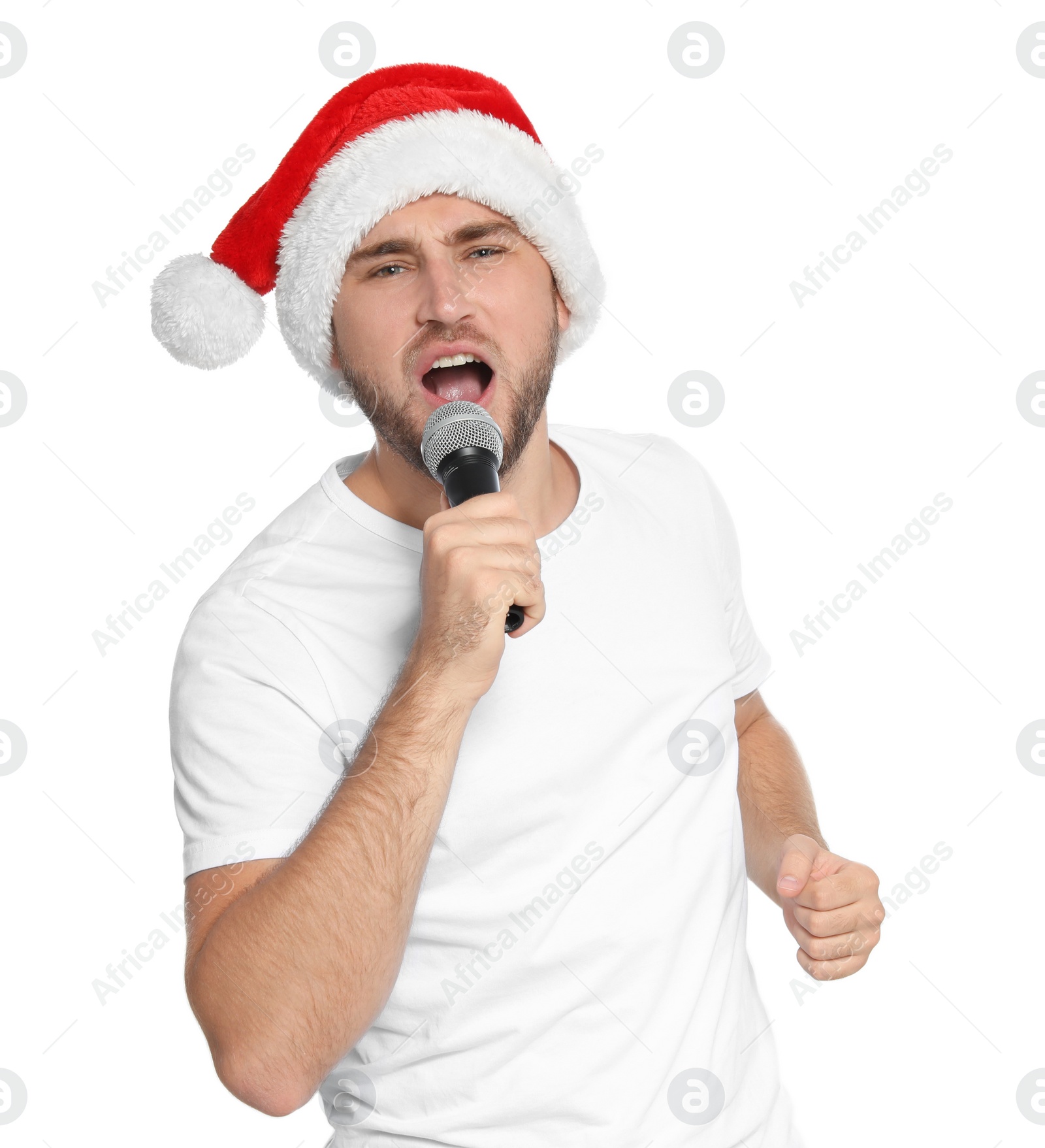 Photo of Young man in Santa hat singing into microphone on white background. Christmas music