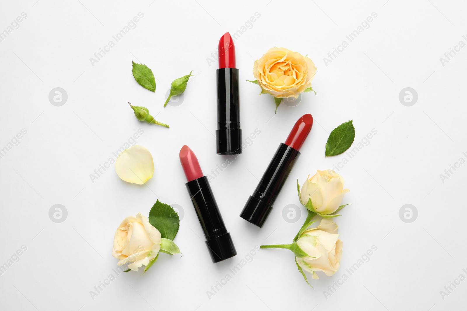 Photo of Flat lay composition with lipsticks and roses on white background