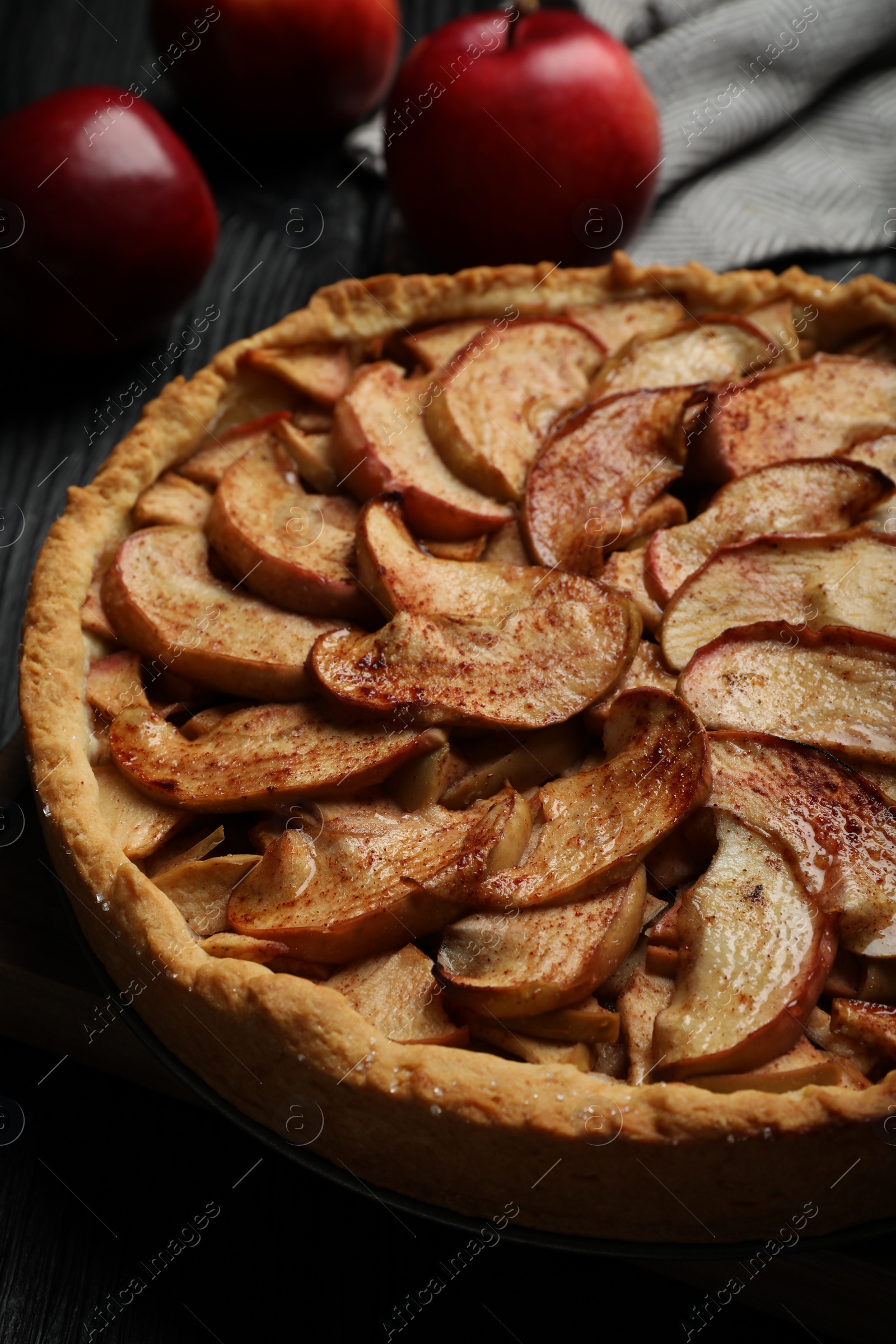 Photo of Delicious apple pie and fresh fruits on black table, closeup