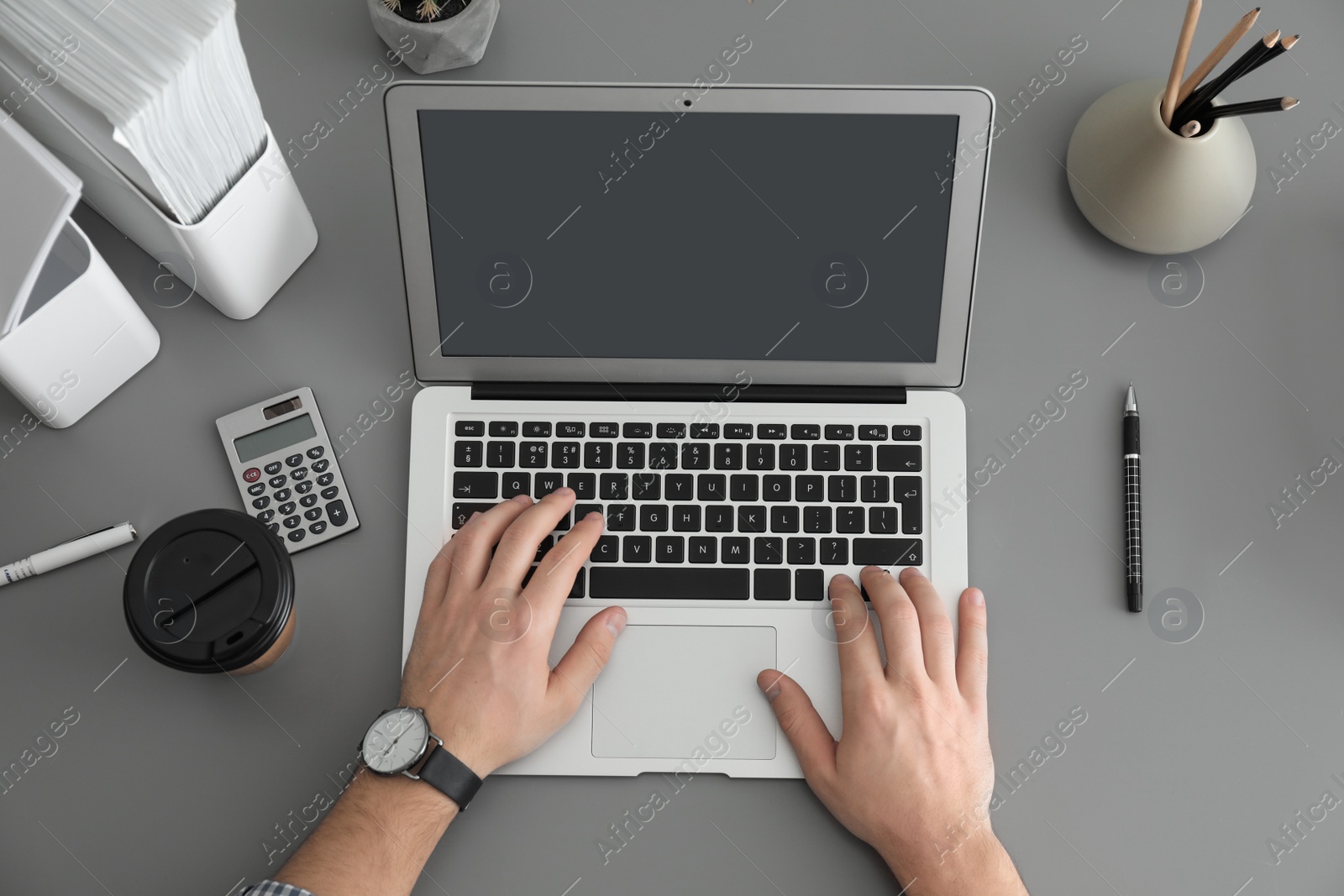 Photo of Man using laptop at table, top view. Space for design