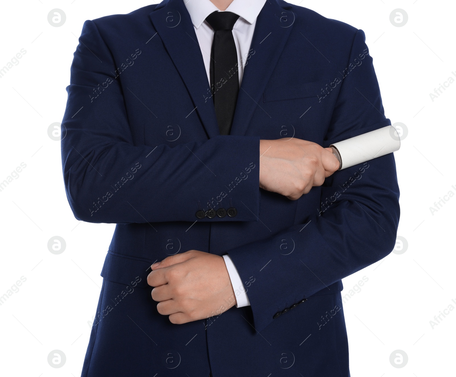 Photo of Man cleaning suit with lint roller on white background, closeup