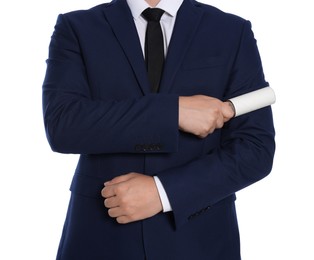 Man cleaning suit with lint roller on white background, closeup