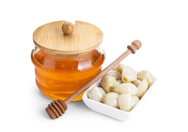 Photo of Peeled garlic cloves, jar with honey and dipper isolated on white