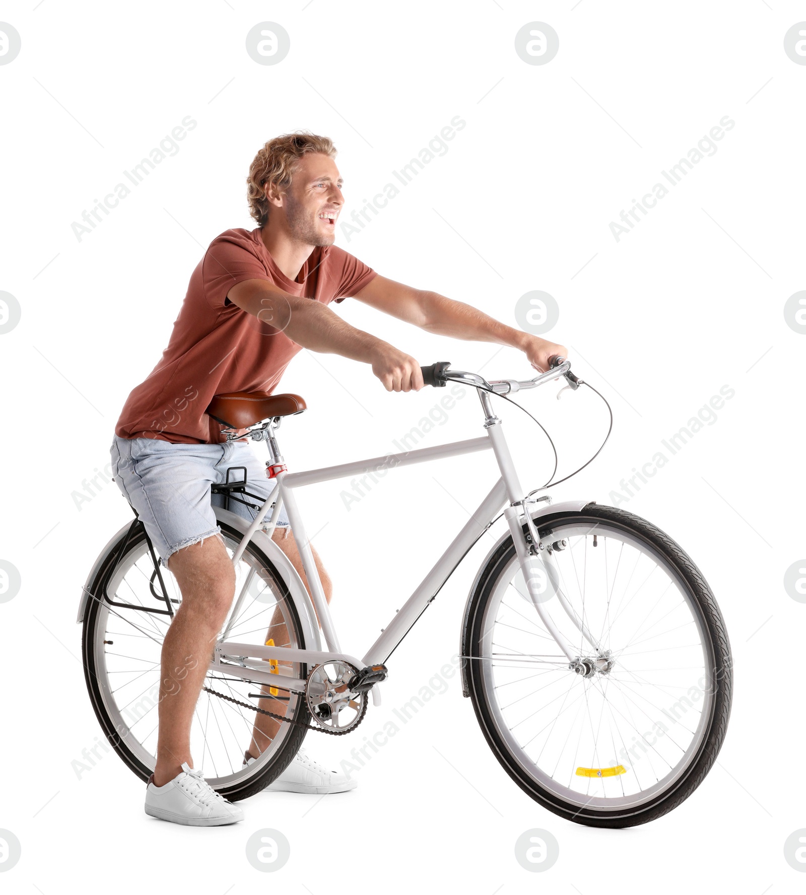 Photo of Handsome young man riding bicycle on white background