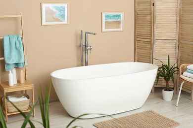 Photo of Stylish bathroom interior with white beautiful tub