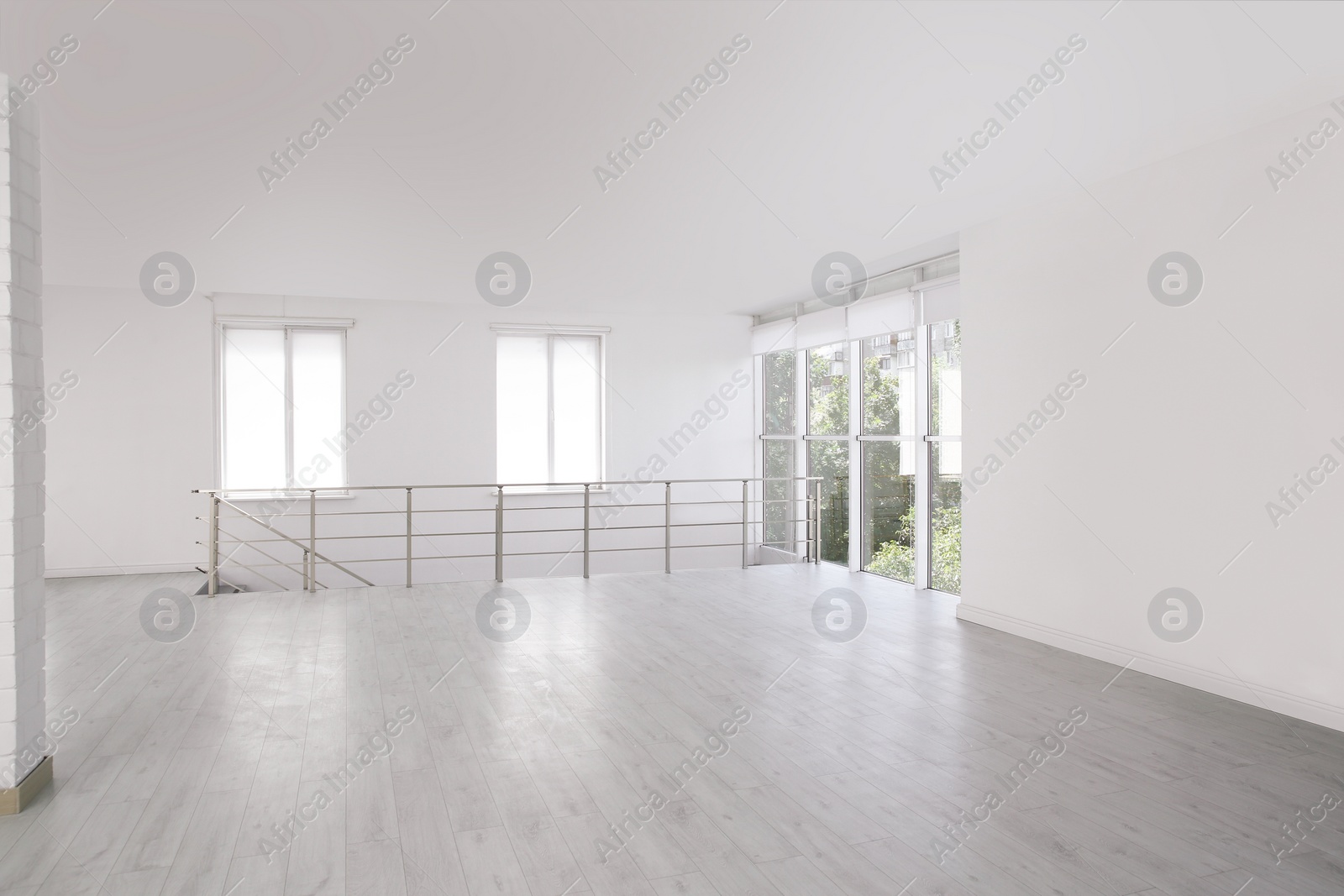 Photo of Empty room with windows and laminated floor