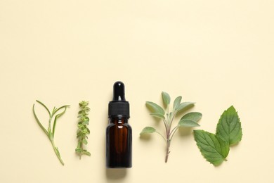 Bottle of essential oil and different herbs on beige background, flat lay. Space for text