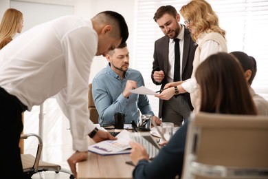 Photo of Businesspeople having meeting in office. Management consulting