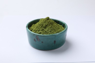 Green matcha powder in bowl isolated on white