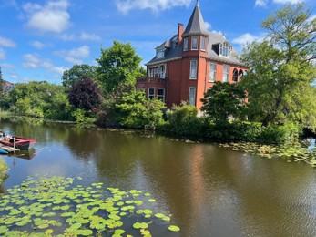 Photo of Beautiful view of house near river on sunny day