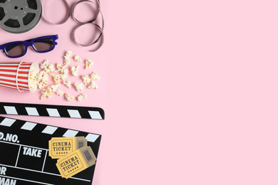 Photo of Flat lay composition with clapperboard and cinema tickets on pink background, space for text
