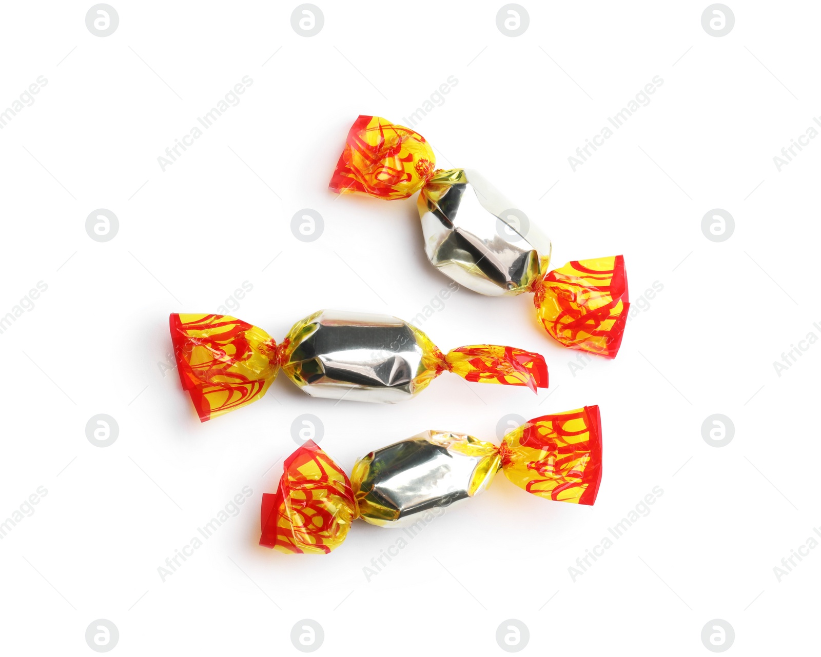 Photo of Delicious candies wrapped in foil on white background, top view