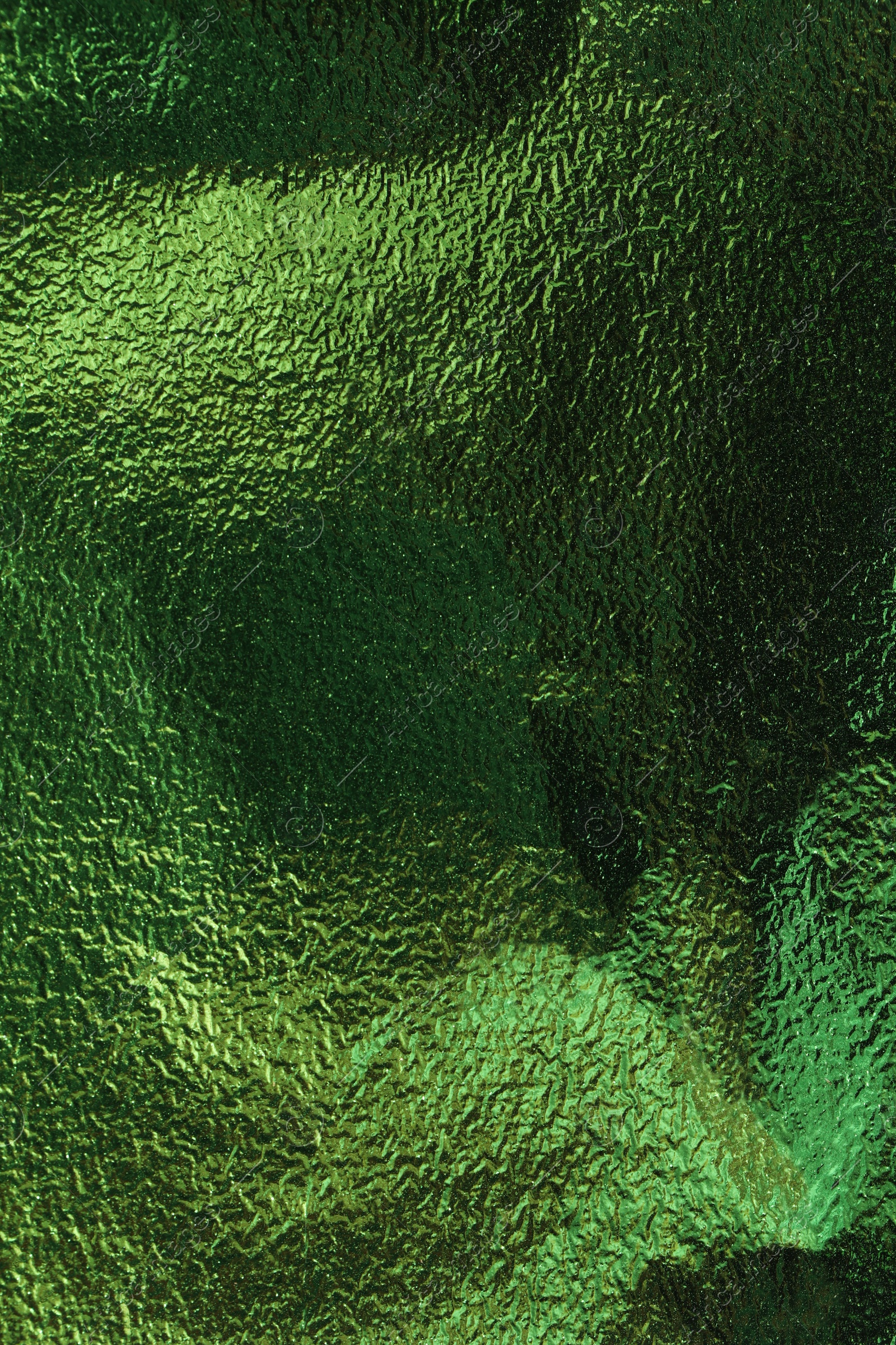 Photo of Textured green foil as background, top view