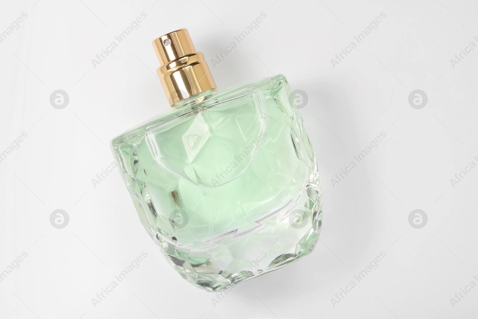 Photo of Luxury women's perfume in bottle on white background, top view