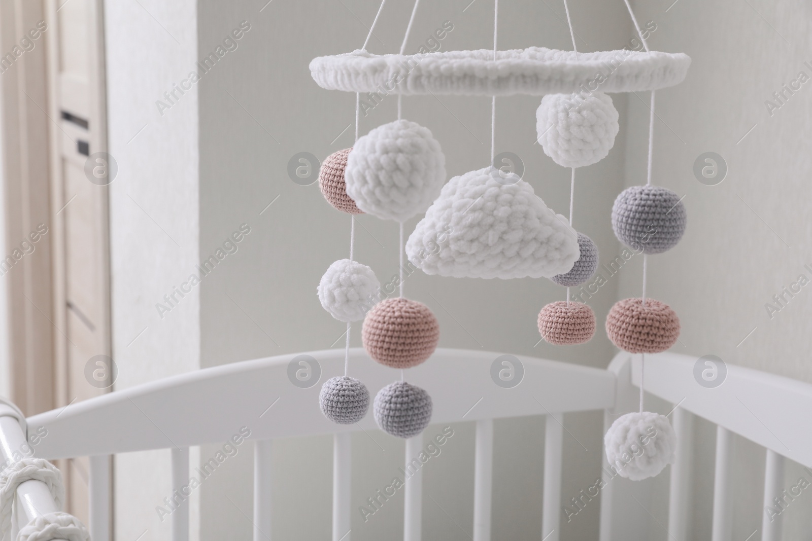 Modern baby mobile under crib in children's room Photo of Modern baby mobile under crib in children's room