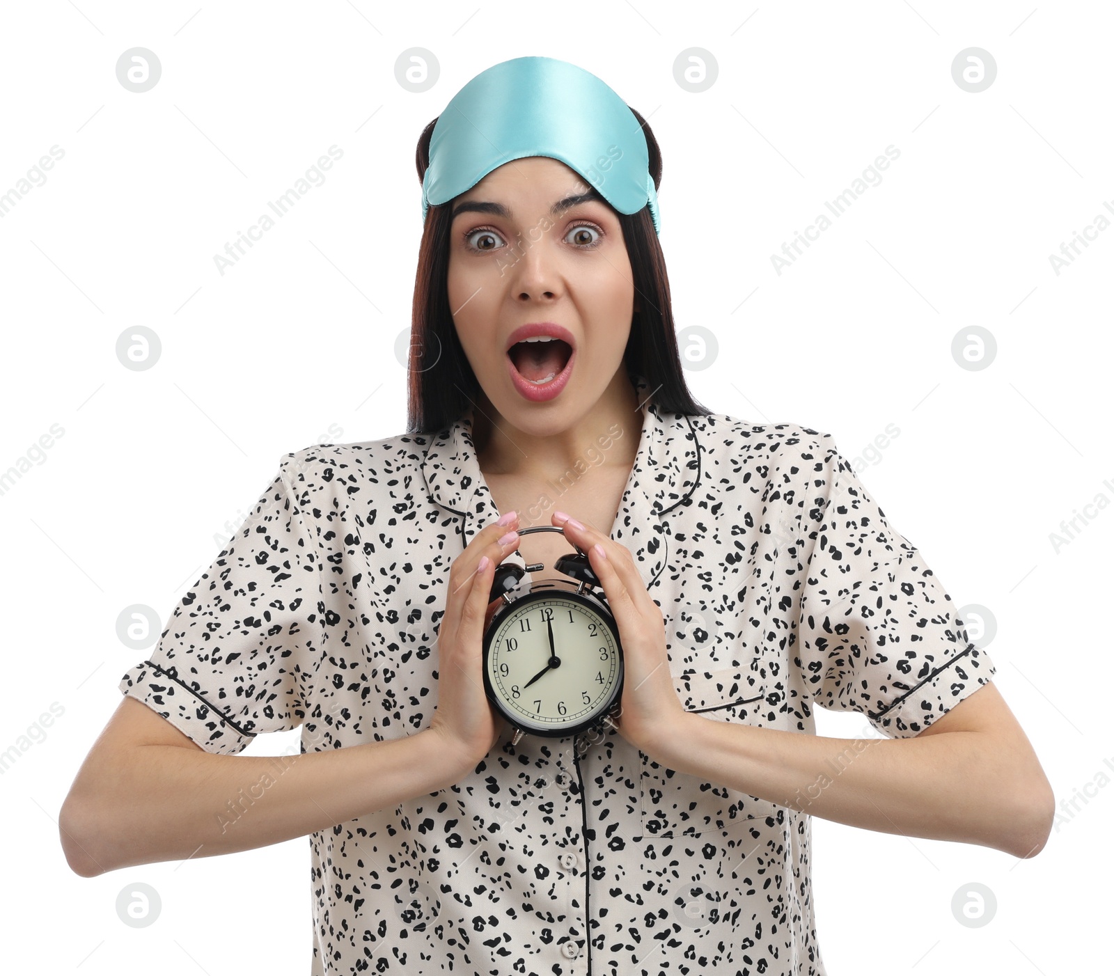 Photo of Emotional overslept woman with alarm clock on white background. Being late concept