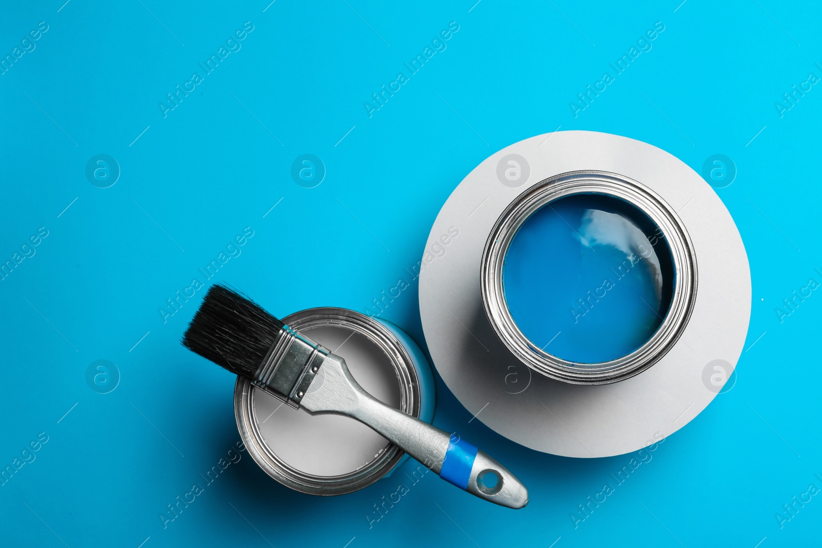 Photo of Flat lay composition with paint cans and space for text on color background