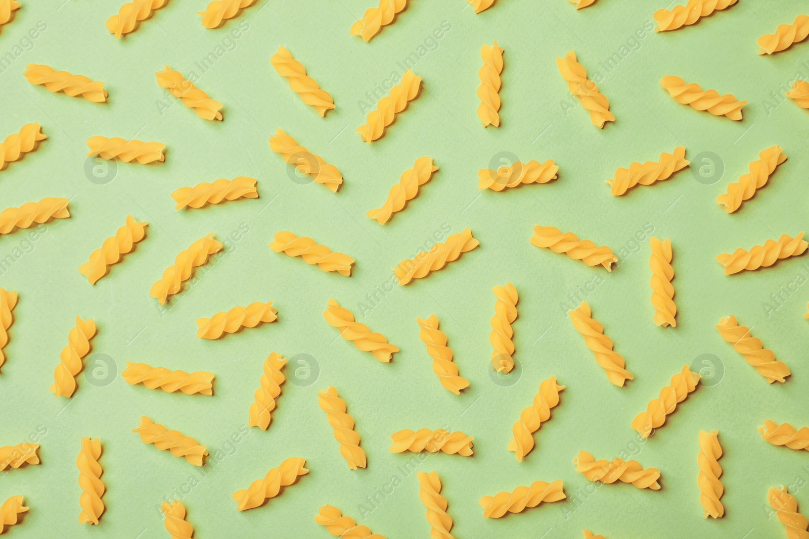 Photo of Flat lay composition with raw pasta on color background