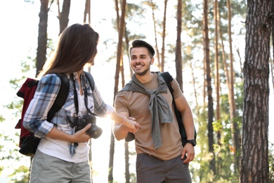 Photo of Young couple in forest on summer day. Camping season