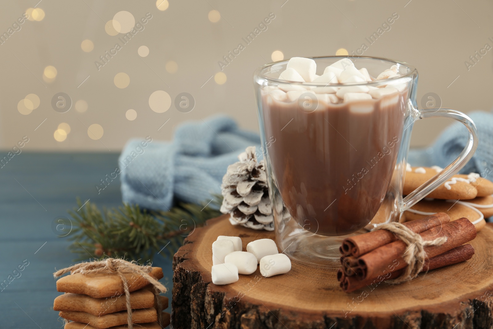 Photo of Composition with hot drink, marshmallows, cinnamon and cookies on table