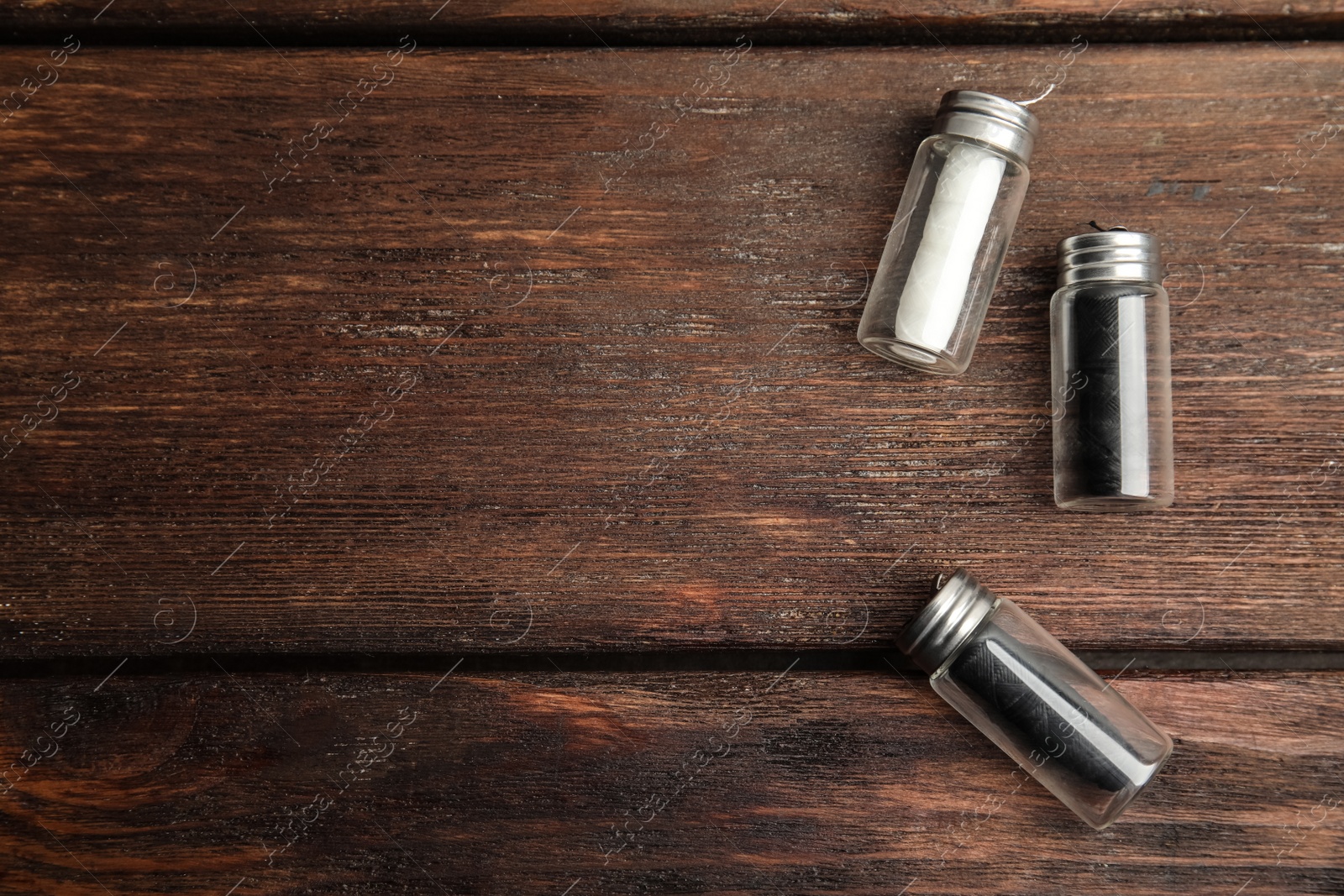 Photo of Flat lay composition with natural dental floss on wooden background. Space for text