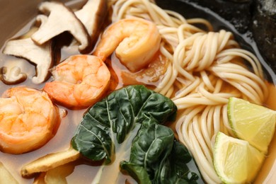 Photo of Delicious ramen with shrimps and mushrooms in bowl, closeup. Noodle soup