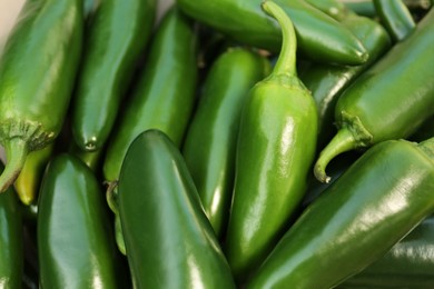 Green hot chili peppers as background, closeup