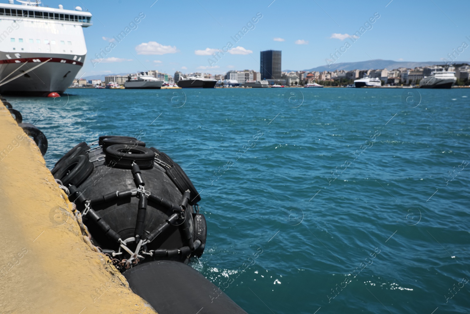 Photo of Black floating fender in sea port on sunny day
