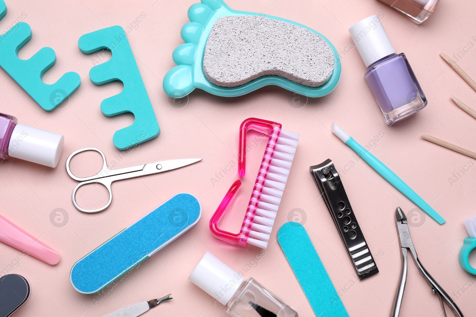 Photo of Set of pedicure tools on pink background, flat lay