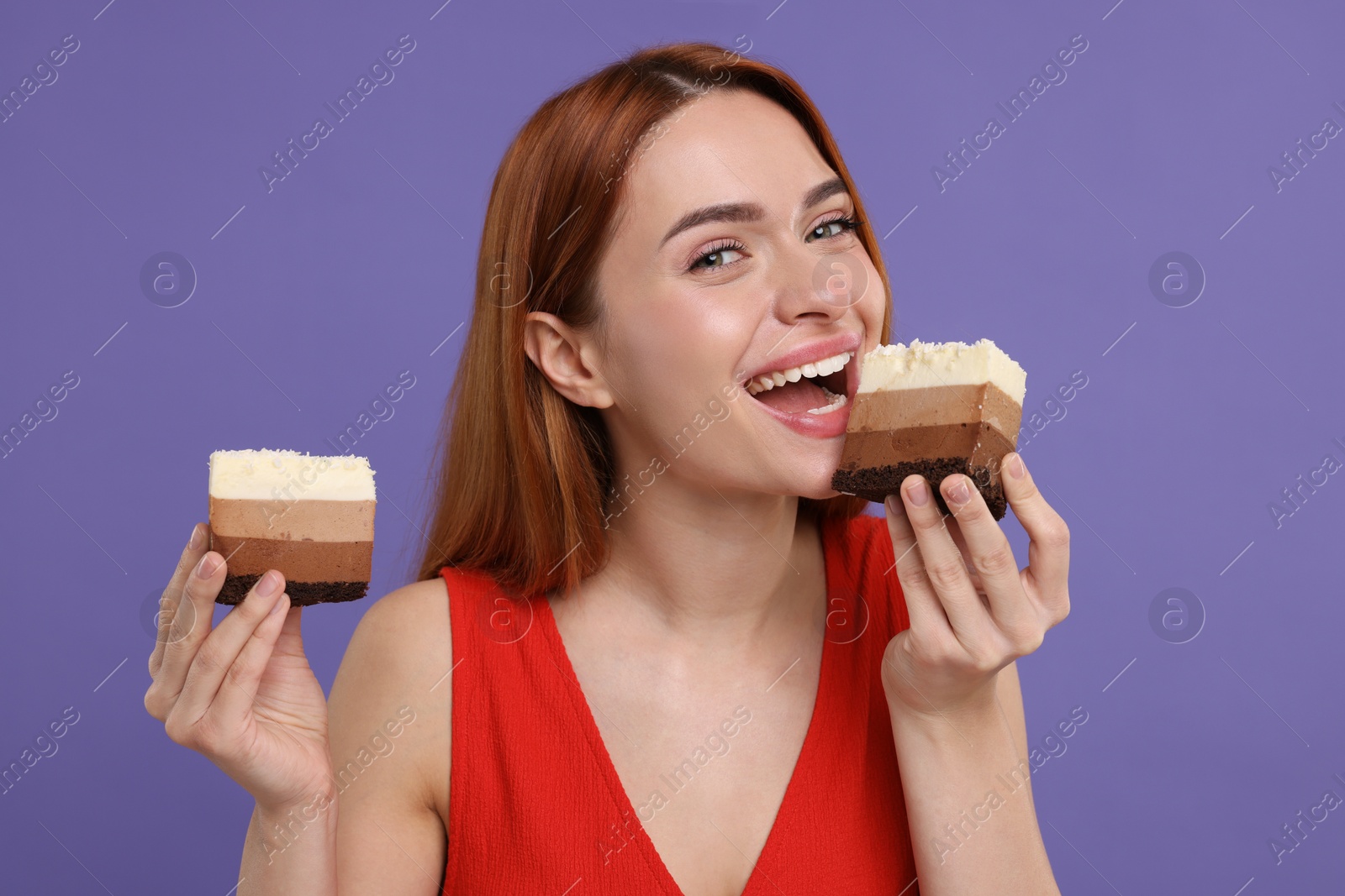 Photo of Young woman eating pieces of tasty cake on purple background