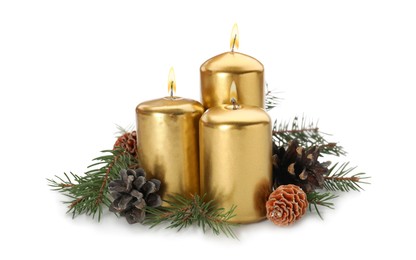 Photo of Burning golden candles with Christmas decor isolated on white