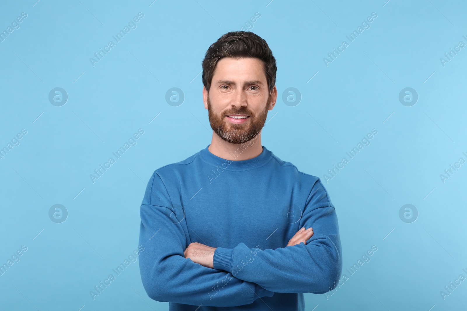 Photo of Portrait of handsome man on light blue background