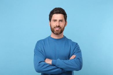 Photo of Portrait of handsome man on light blue background