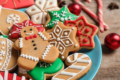 Tasty homemade Christmas cookies on blue plate, closeup view