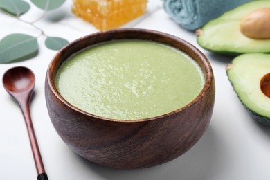 Homemade hair mask and ingredients on white background