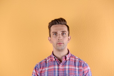 Handsome young man on color background