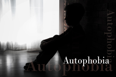 Image of Depressed little boy sitting alone near brick wall. Autophobia - fear of isolation