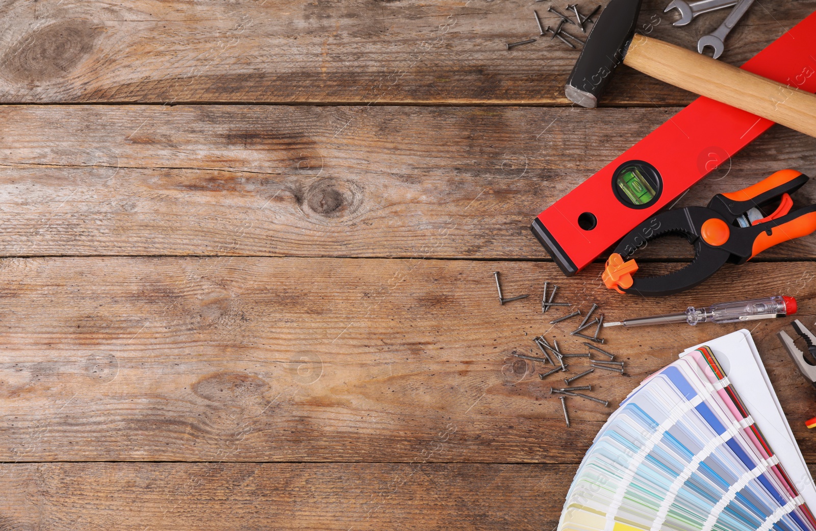 Photo of Flat lay composition with construction tools on wooden background. Space for text