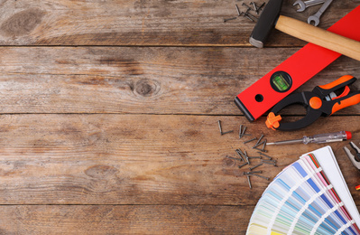 Photo of Flat lay composition with construction tools on wooden background. Space for text