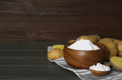 Starch and fresh raw potatoes on wooden table. Space for text