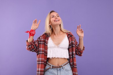 Portrait of happy hippie woman on purple background