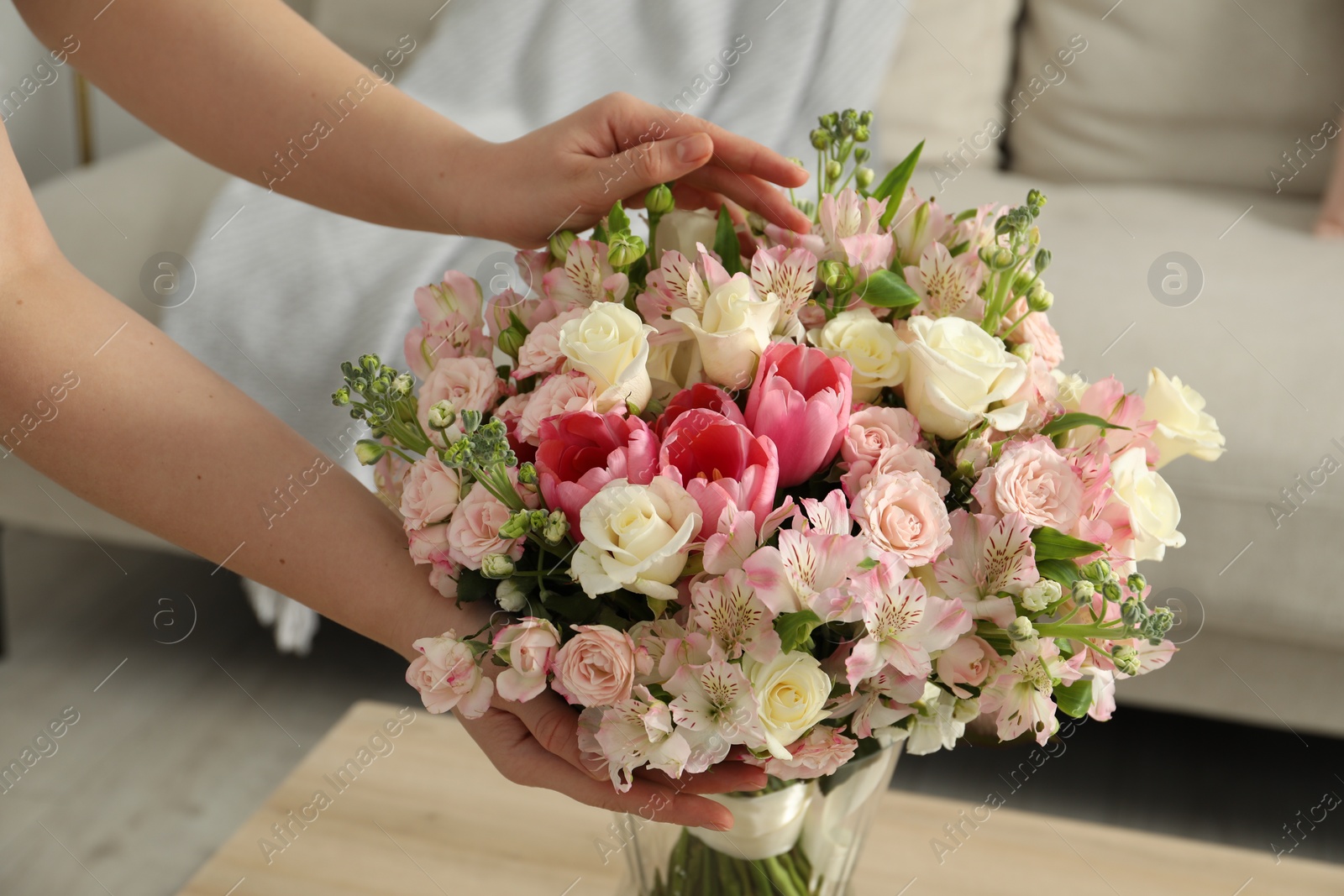 Photo of Woman with beautiful bouquet of fresh flowers at home, closeup