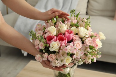 Woman with beautiful bouquet of fresh flowers at home, closeup