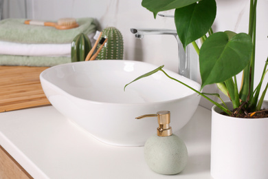 Stylish vessel sink on light countertop in modern bathroom