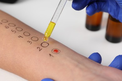 Photo of Patient undergoing skin allergy test at light table in clinic, closeup