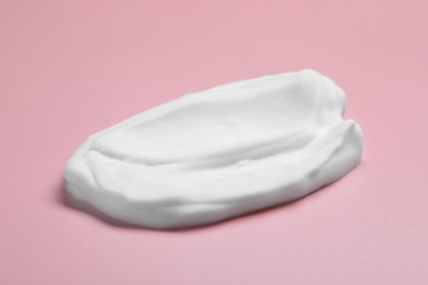 Photo of Sample of shaving foam on pink background, closeup