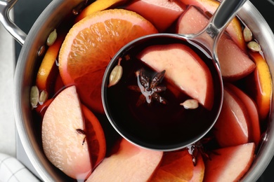 Photo of Delicious hot mulled wine in pot, top view