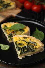 Photo of Pieces of delicious pie with spinach on table, closeup