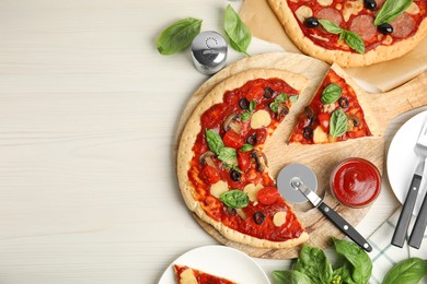 Photo of Delicious homemade pita pizza on white wooden table, flat lay. Space for text
